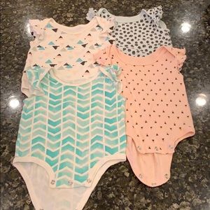 Four Rosie Pope baby ruffle sleeve onesies